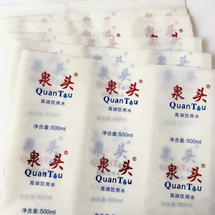 Stack of printed bottled-water labels in blue and white