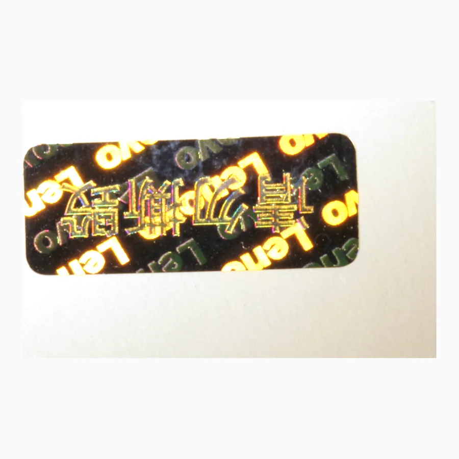 Circular tamper-evident holographic seal with a chequered diffraction field and warning text