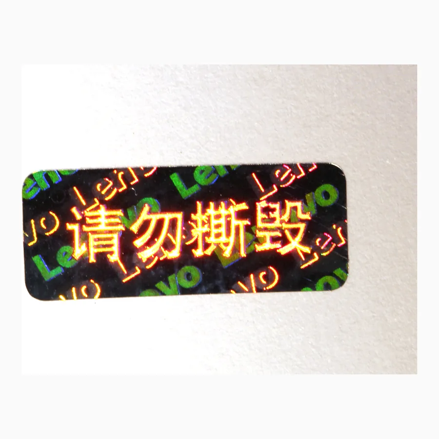 Circular tamper-evident holographic seal with a chequered diffraction field and warning text