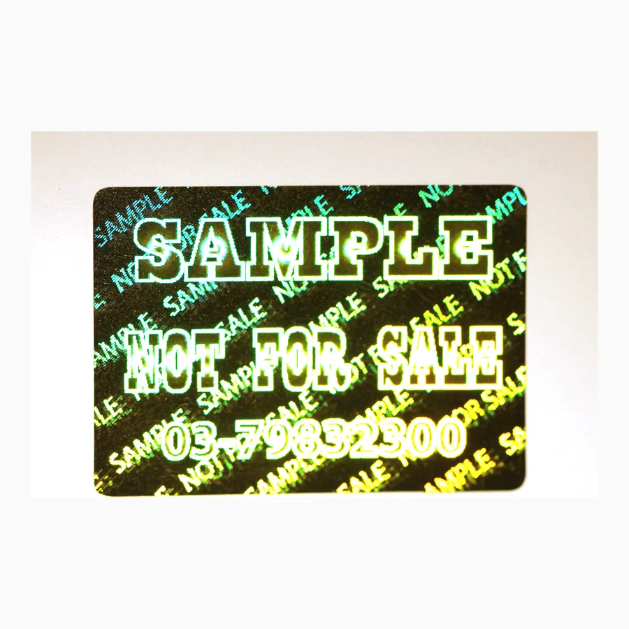 Circular tamper-evident holographic seal with a chequered diffraction field and warning text